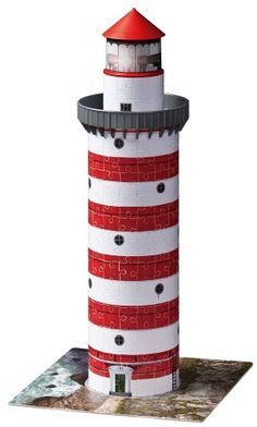 a red and white lighthouse on top of a piece of paper that is cut out