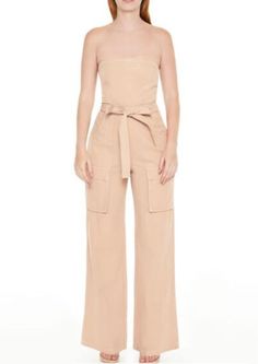 Elevate your wardrobe with this chic Strapless Tie-Front Cargo Jumpsuit in Almond. Perfect for a day out or casual evenings, this stylish jumpsuit combines comfort and fashion with its flattering fit and trendy cargo pockets. The tie-front detail adds a feminine touch to the relaxed silhouette. Shop now for a versatile addition to your closet! Cargo Jumpsuit, Stylish Jumpsuit, Casual Evening, Princess Seams, Princess Seam, Straight Cut, Playsuit Jumpsuit, Jumpsuits For Women, Jumpsuit Romper