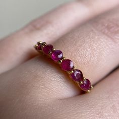 This genuine Ruby ring is made to order in your size. Please allow us 2-4 weeks to create your ring and get it delivered to your doorstep Ships from our California home studio. Thank you for supporting a small business!  3mm Natural Rubies Color - Dark Pink 7 Stone Half Eternity Band 925 Sterling Silver  - Plantinum Plated - 18k Gold Plated - 18K Rose Gold Plated 3.5mm top height  1.5mm bottom babd width Anniversary Ruby Eternity Band With Round Cut, Ruby Half Eternity Band Gift, Ruby Half Eternity Band As A Gift, Ruby Eternity Band Gift, Ruby Half Eternity Ring As Gift, Ruby Stackable Rings With Prong Setting, Stackable Ruby Eternity Band With Round Cut, Stackable Round Cut Ruby Eternity Band, Stackable Ruby Ring With Round Cut For Anniversary