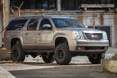 a silver truck parked in front of a building