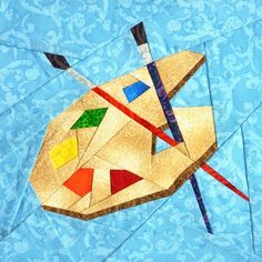 a piece of art that has been made to look like a kite with different colors and shapes