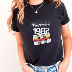 "Looking for a unique and personalized gift for a music lover? Our Personalized Mixtape Shirt is the perfect choice! This 90's cassette tape shirt features a vintage mixtape design, complete with a customizable text label for a personalized touch. It's the perfect way to show off your love for music and your unique style. Made from high-quality materials, this 80s-inspired shirt is comfortable and durable, making it perfect for everyday wear. Get yours today and take a trip down memory lane with this retro-inspired shirt! .  This vintage mixtape shirt is great for celebrating that special birthyear! This shirt can always be customized (Year, Month, Mixtape Message). Just add your custom requests to the \"notes to seller\" section when ordering. .: 100% ring-spun cotton .: Medium fabric (6. School Playlist, Text Label, Custom Birthday Shirts, Song Name, Bee Gifts, Cassette Tape, Custom Birthday, Gift For Birthday, Music Lover