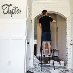 a man standing on top of a step stool