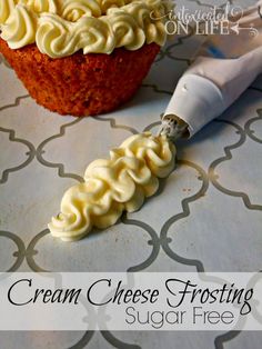 a cupcake with cream cheese frosting next to a sugar free icing brush