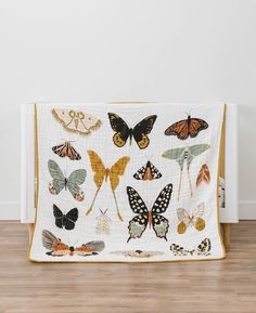 a white crib with many different butterflies on it