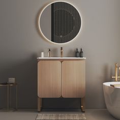 a white bath tub sitting next to a round mirror