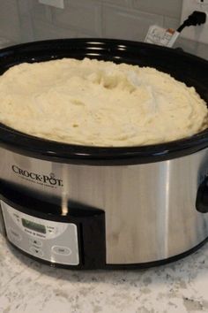 a crock pot with mashed potatoes in it