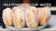 powdered sugar covered doughnuts on a plate with the words milk powdered - flour water