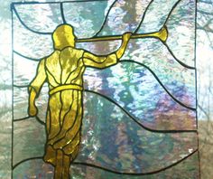 a stained glass window with a man holding a stick