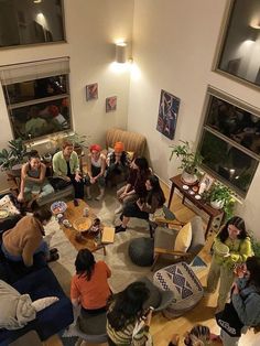 a group of people sitting in a living room together