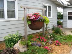 a potted planter filled with flowers in front of a house