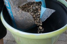 a trash can filled with rocks and gravel