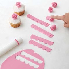 cupcake decorating supplies being used to decorate cupcakes with pink icing