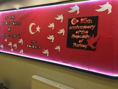 a large red sign with white birds and words on it that read, the 50th anniversary of the republic of turkey