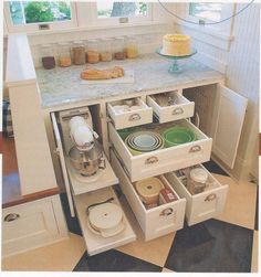 an open drawer in the middle of a kitchen