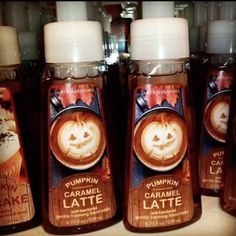 three bottles of pumpkin latte coffee on a shelf