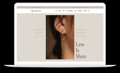 the website for jewelry store is displayed on an open laptop computer, with ear piercings hanging from it's side