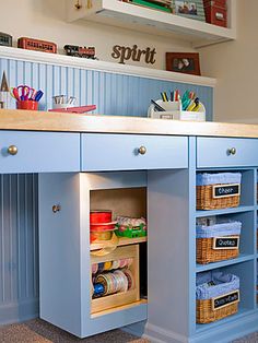 a blue desk with lots of drawers underneath it