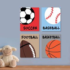 a teddy bear is sitting next to three sports themed canvases on the wall above a wooden table