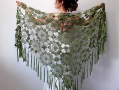 a woman wearing a green shawl with flowers on it