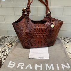 Brahmin - Melbourne Style “Emily” In A Beautiful Pecan Color. Interior Has Several Zippered Pockets. On The Back Is A Large Slip Pocket. Comes Complete With Registration Card And Dust Bag. In Excellent Condition No Cracks No Scuffs. Small Pen Mark On The Bottom Of The Interior. See Photo. From Smoke-Free Home. It Is A Gorgeous Bag! Melbourne Style, Color Interior, Brahmin Bags, Brahmin Handbags, Small Pen, Gorgeous Bags, Womens Tote Bags, Melbourne, Dust Bag