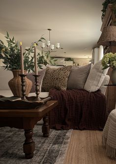 a living room filled with lots of furniture and flowers on top of a coffee table