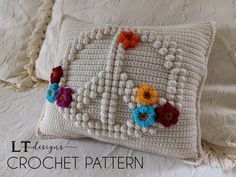 a crocheted pillow with flowers on it