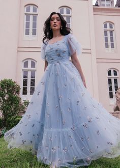 See The Lights, See The Party, The Ball Gowns This beautiful blue gown will make you feel like a true royal. The floral embroidery is a subtle, yet stunning detail, and the full skirt adds a touch of whimsy to the overall look. Perfect for attending a gala or dancing under the stars. Sweetheart neckline 3/4 sheer flutter sleeves Back zipper Ruched bodice Fully lined Consider sizing down Model Details Content + Care 100% Polyester Hand wash only Try On Video Highgrove Dress Try On Video XS & XL Full Sleeve Gown Designs, Simple Gown Designs, Fairytale Clothes, Dresses For Engagement Pictures, Moh Dress, Full Sleeve Gowns, Light Blue Gown, Simple Frock, Outfit Ideas Summer