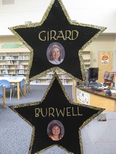 three star shaped plaques with two women's heads on them in front of a library