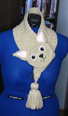 a crocheted dog scarf on top of a blue mannequin's torso