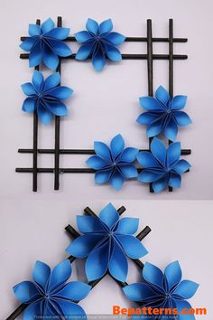 paper flowers are arranged on black sticks