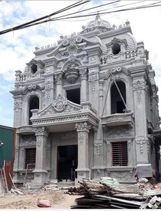 a large white building sitting on top of a pile of rubble