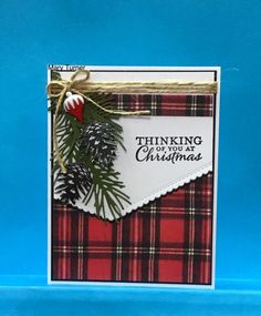 a christmas card made with plaid paper and pine cones