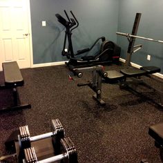 an empty gym room with equipment in it