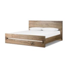 a wooden bed frame with white sheets and pillows