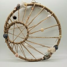 an old wheel made out of rope with seashells on it