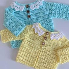 two knitted sweaters with buttons on the collar and sleeves, one in yellow and one in blue