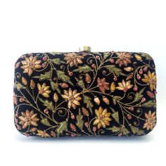 "Beautiful designer luxury black velvet hard case clutch bag, hand embroidered with a rich palette of caramel colored flowers and embellished with ruby gemstones. This will be your go to purse for any wedding! A classic design that never goes out of style. Expertly hand embroidered by third generation zardozi artisans. The word Zardozi means \"gold thread\". It is an elaborate and intricate multidimensional embroidery using metallic threads and genuine precious and semi precious gemstones. A cen Bride Purse, Velvet Clutch Bag, Embellished Purses, Clutch Purse Black, Floral Handbags, Floral Clutches, Velvet Clutch, Wedding Purse, Wedding Clutch