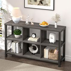 a shelf with books, fruit and other items on it in a living room setting