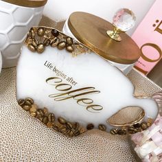 there is a white and gold heart shaped object on the table next to other items