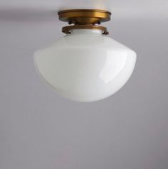 a white light hanging from a ceiling fixture