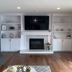 a living room with a fireplace and entertainment center