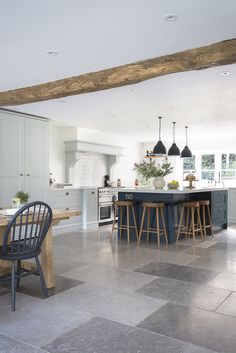 a kitchen with an island and chairs in it