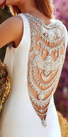 the back of a woman's dress with beading on it