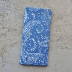 "This double eyeglass case is a great organizer case for 2 pairs of eyeglasses. Made up in a soft blue paisley cotton fabric, there is a blue cotton fabric lining. Case has 2 pockets. The main pocket will accommodate your sunglasses or eyeglasses and the outside pocket is an easy slip in for your readers or a second pair of glasses. Both pockets are fully lined and interfaced for good structure. The outside pocket has a decorative embroidery top stitching. If you prefer, an alternate use for thi Blue Rectangular Case For Everyday Use, Blue Rectangular Case For Personal Use, Blue Cases With Pen Holders For Daily Use, Blue Cases With Pen Holders, Decorative Embroidery, Blue Cotton Fabric, Leopard Print Fabric, Paisley Fabric, Embroidery Top