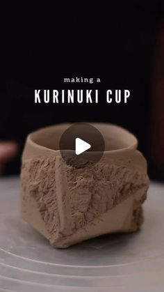 a cup made out of clay sitting on top of a white plate with the words making a kurinuk cup