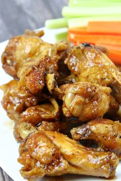 chicken wings and carrots on a white plate