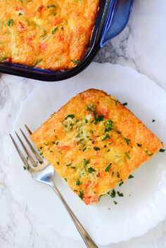 a piece of quiche on a plate with a fork next to the casserole