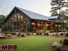 a large house sitting in the middle of a lush green field with lots of trees