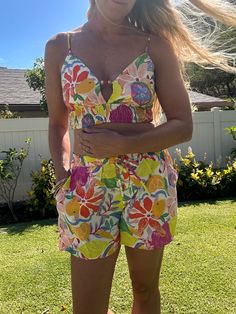 These Calabash printed shorts feature a playful print, matching tops, and convenient side pockets. The partially lined top adds a fun touch to this unique piece. Perfect for those with a height of 5'7'' and measurements of 32'' bust, 24'' waist, and 35'' hips. Beach Tops With Pockets, Short Length, Beach Tops With Pockets, Short Style, Beach Tops With Pockets And Short Length, Vacation Tops With Pockets Short Length, Short Length Tops With Pockets For Vacation, Short-length Tops With Pockets For Vacation, Short Length Beach Tops With Pockets, Playful Beach Shorts With Pockets, Playful Vacation Shorts With Pockets